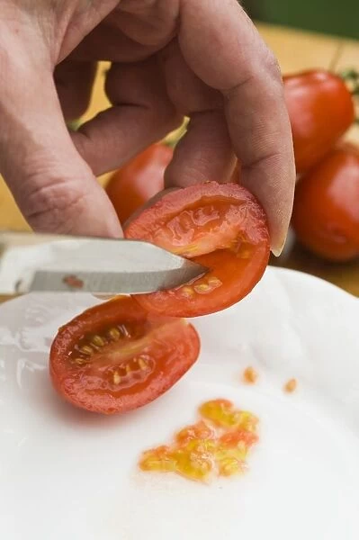 Using knife to remove seeds from ripe tomato
