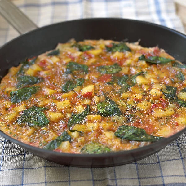 Vegetable frittata in frying pan, close-up