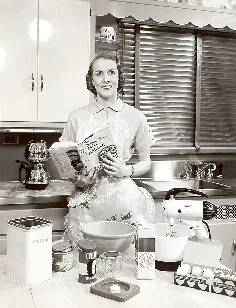 Woman with apron holding cookbook
