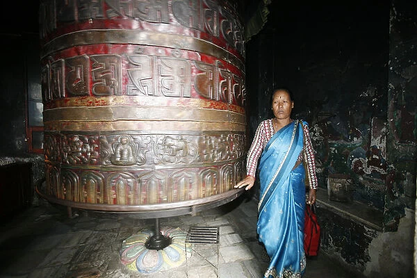Woman and prayer wheel
