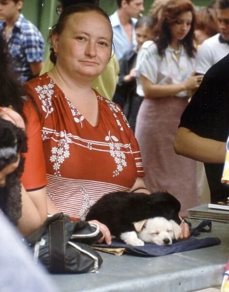 Woman selling puppies at a pet market in moscow, 1989