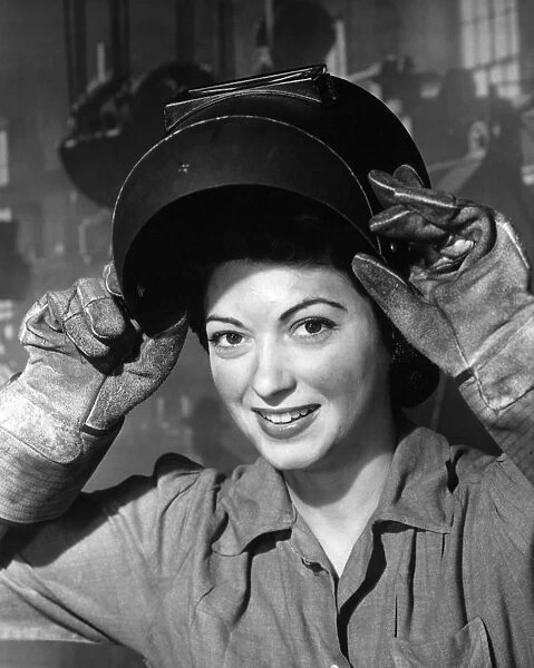 Woman wearing welding mask and gloves in wartime