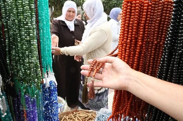 Women buying prayer beads