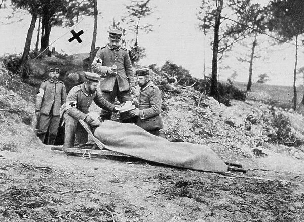 World War I 1914-1918: Wounded German soldier on a stretcher being treated behind