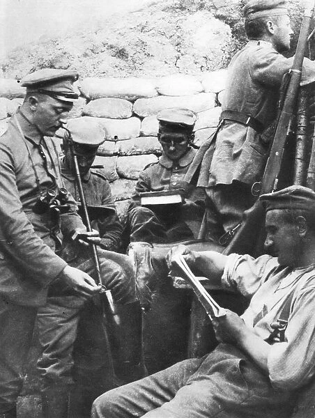 World War I: German soldiers reading, writing and smoking in the trenches during