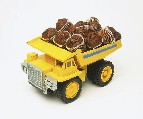 Yellow toy truck loaded with chocolate muffins