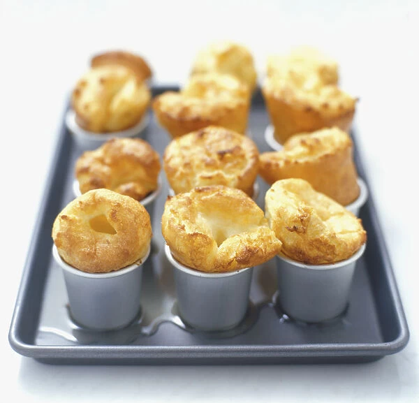 Yorkshire Pudding, baked in nine dariole moulds, on a baking tray