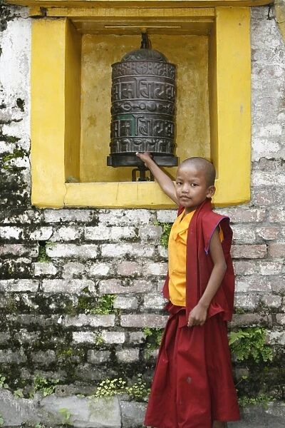 Young monk and prayer wheel