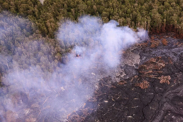 Aerial view of lava from Mauna Loa and burning forest, Big Island, Hawaii, USA