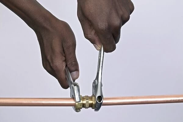 Tightening nuts to a compression joint attached to copper pipes using adjustable spanners