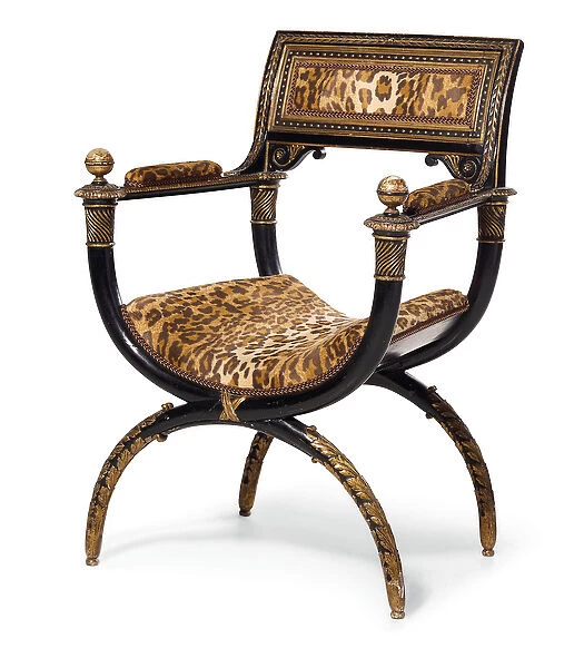 A Directory curule armchair, c. 1795 (ebonised & gilded wood with leopard print upholstery