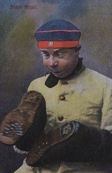 German soldier looking at the soles of his boots (coloured photo)