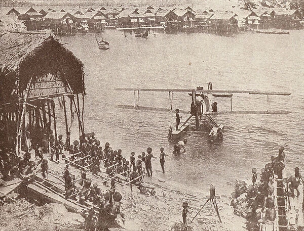 Papuans investigating a seaplane (b  /  w photo)