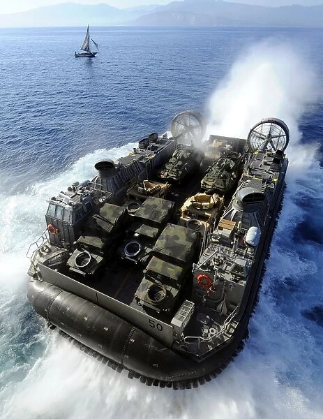 A Landing Craft Air Cushion exits the well deck of USS Bataan