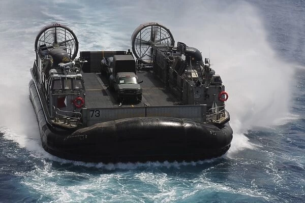 A Landing Craft Air Cushion prepares to enter the well deck of USS Essex
