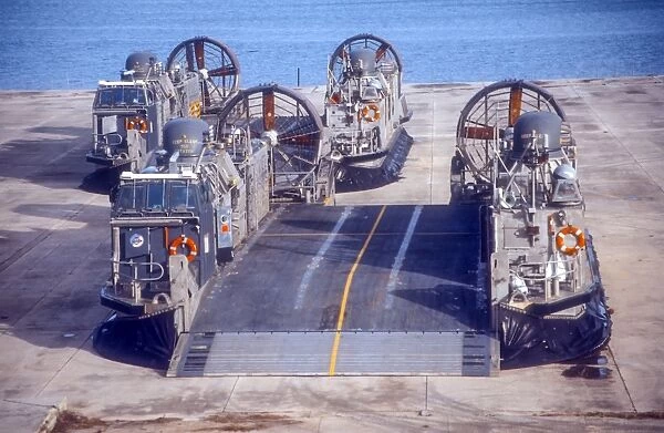 A pair of Navy landing craft air cushions rest on the old World War II seaplane ramps