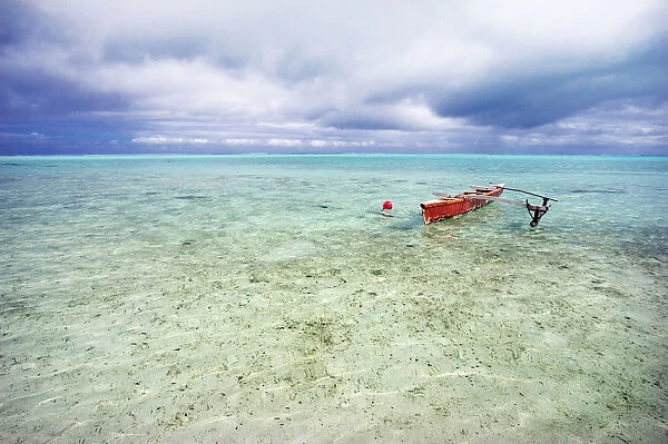 French Polynesia, Tahiti, Bora Bora, Red Outrigger Canoe In Calm Turquoise Water