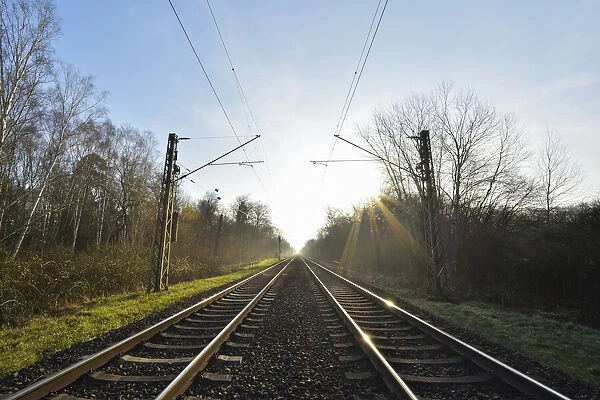 Railroad tracks with Sun, Arheiligen, Darmstadt, Hesse, Germany