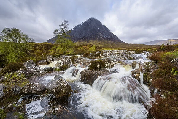 Waterfall on River Coupal and mountain range Buachaille Etive Mor at Glen Coe in Scotland, United Kingdom