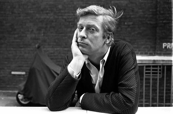 Actor Michael Caine 1964 posing with his chin resting in his hand