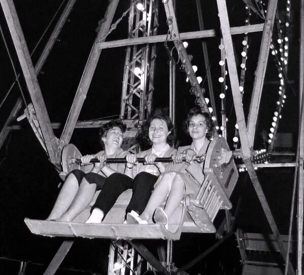 As the big Wheel turns, these three ladies can y help but smile