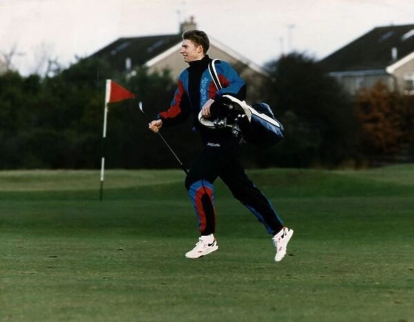 Brian Whittle athlete runner running across golf course carrying golf clubs