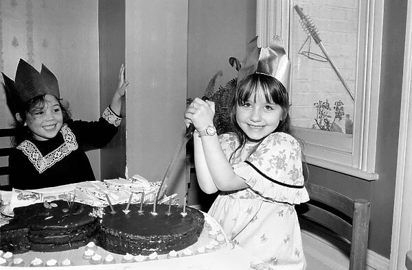 Childrens birthday party: The birthday girl cuts the cake. March 1981 PM 81-01186b