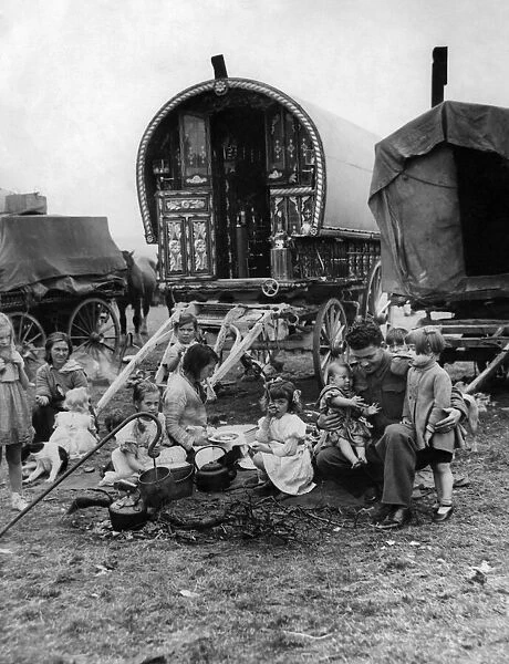 Gipsies Camps. A soldier plays with the children of a Gypsy Campon returning from