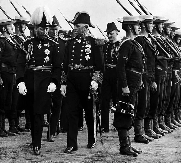 King George V seen here inspecting a naval guard of honour during a visit to Aberystwyth