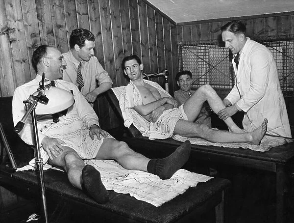 Liverpool footballers in the treatment room at Anfield, seen to by coach Albert Shelley