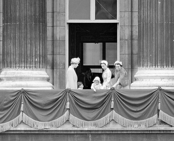 Princess Margaret with Prince Charles and Princess Anne pointing over the balcony of