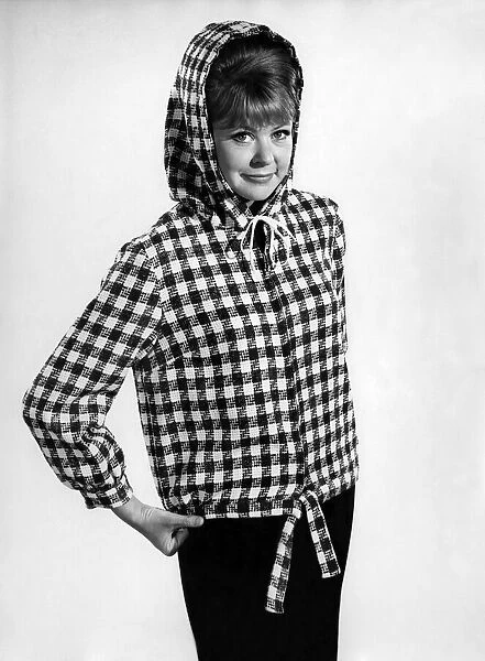 Reveille Fashions 1966: Ann Jarvis wearing check hoodie coat. January 1966 P006671