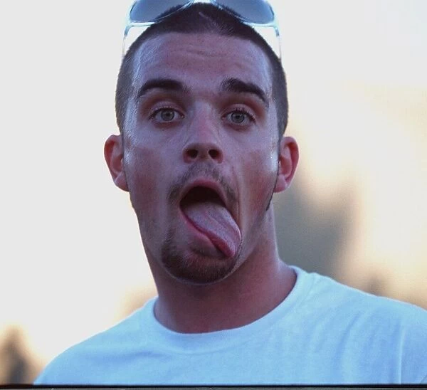 Robbie Williams sticking his tongue out to photographers at T in The Park festival