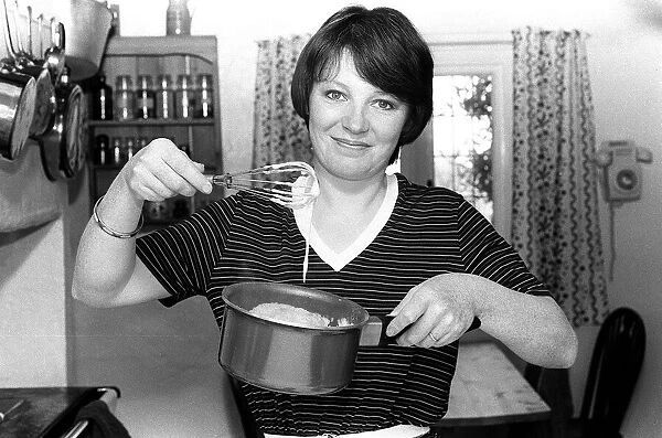 Tv cook Delia Smith at home in kitchen 1981 Mixing with a whisk
