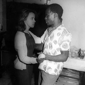 African man and English woman on the dance floor at a party