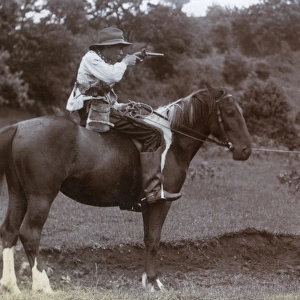 Two boys on horseback playing Cowboys and Indians