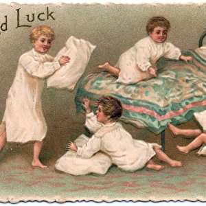 Four boys pillow fighting on a Good Luck card
