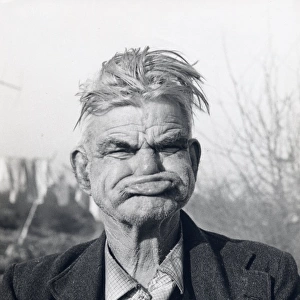 Gipsy man pulling a gurning face, Lewes, Sussex