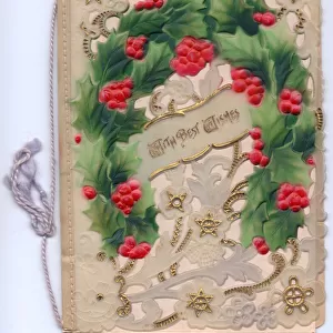Holly and gold stars on an ornate Christmas card