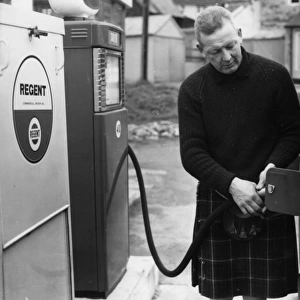 Man in a kilt, filling a van up with petrol