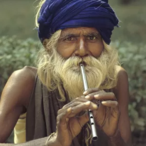 Man playing tin whistle, Agra, India - 1