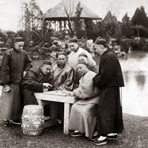 Men playing a board game, China, circa 1880s