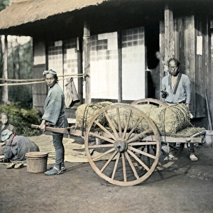 Men with rice bales on cart, Japan