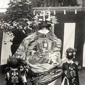 Rear view of a Japanese Actress in remarkably elaborate costume with two children Date