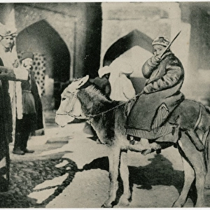 Samarkand, Uzbekistan - A young boy riding his mule