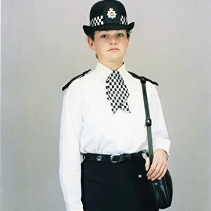Woman police officer in white shirt and bowler hat, London