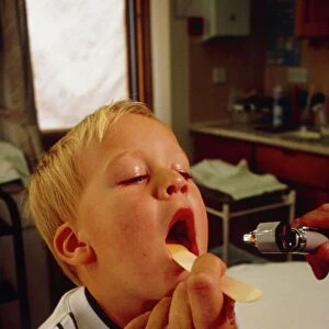 GP examining childs mouth