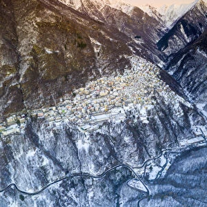 Aerial panoramic by drone of Premana village during winter dusk, Valsassina