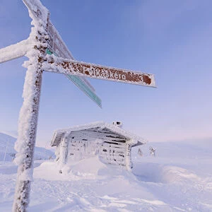 Frozen signage and wood hut, Pallas-Yllastunturi National Park, Muonio, Lapland, Finland