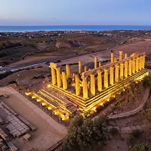 The illuminated Greek Temple of Hera seen from a drone, Valley of the Temples, UNESCO World Heritage Site, Agrigento, Sicily, Italy, Mediterranean, Europe